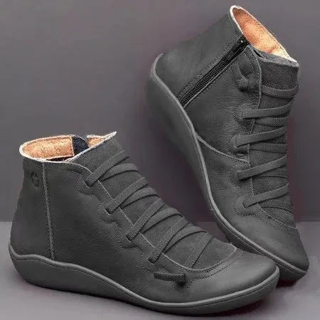 Women's black casual ankle booties with wedge heel and round toe on a rubber sole.