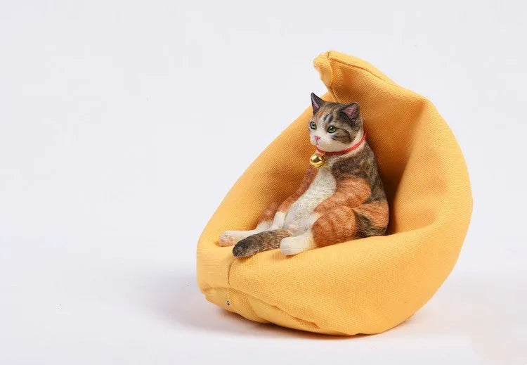 Small lazy cat model resting on a sofa, a resin car dashboard ornament decoration.