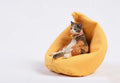 Small lazy cat model resting on a sofa, a resin car dashboard ornament decoration.