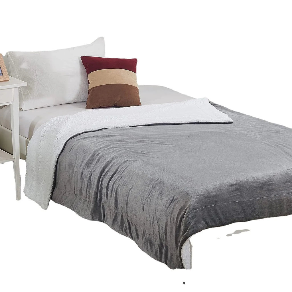 Grey and white USB electric heating blanket with intelligent temperature control on a desk.
