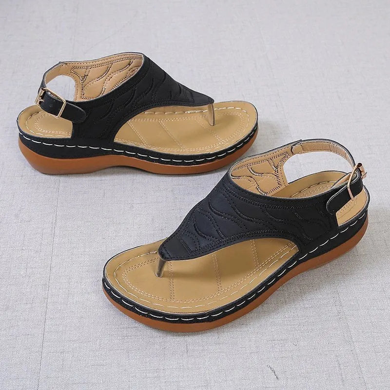 Women's solid colour wedge heel flip flop sandals with an adjustable buckle strap.