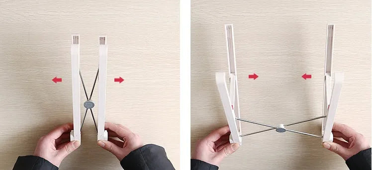 White foldable laptop stand on a desk, showing its elevated, angled position for ergonomic use.
