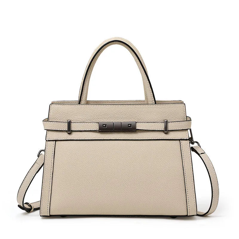Women's genuine leather crossbody bag in horizontal square shape with clamshell opening showing internal organisation pockets