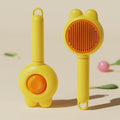 Green self-cleaning pet brush with a metal comb, release button, and comfort-grip handle for grooming cats and dogs.