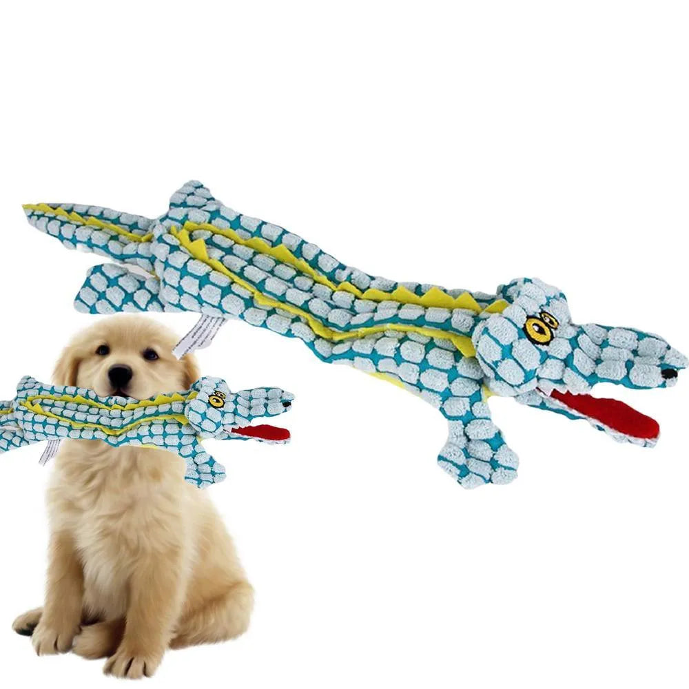 Blue crocodile-shaped plush squeaky dog toy with corduroy fabric on a wooden floor.