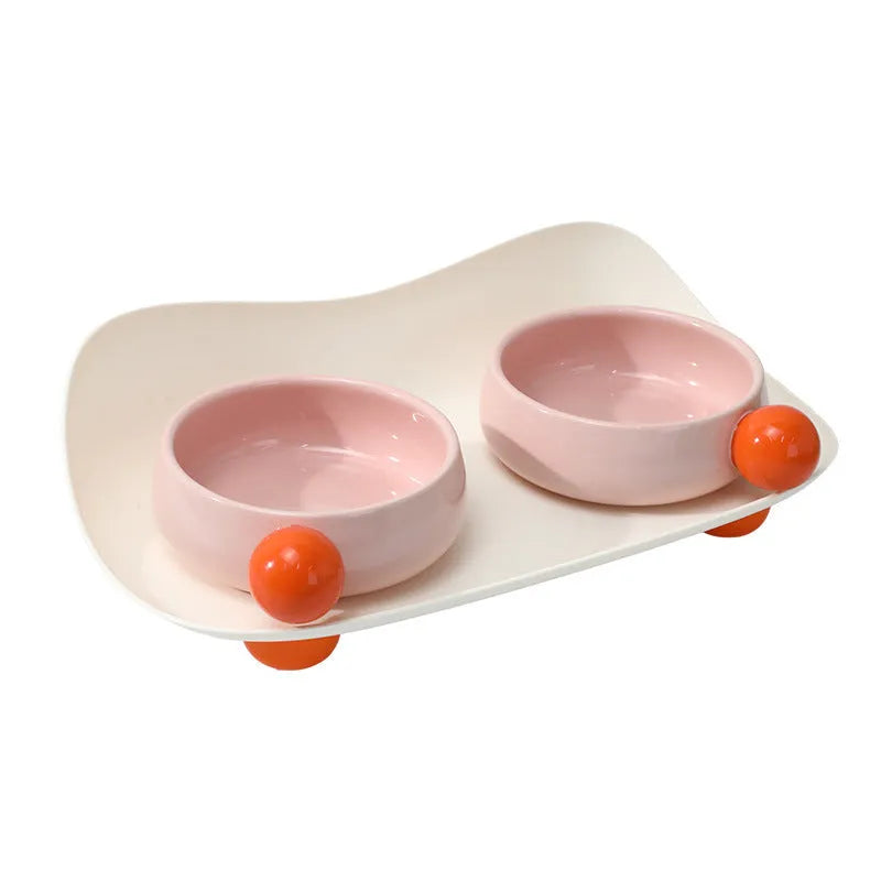 Elevated ceramic pet feeding bowl with two compartments and a non-slip base in a choice of colours.