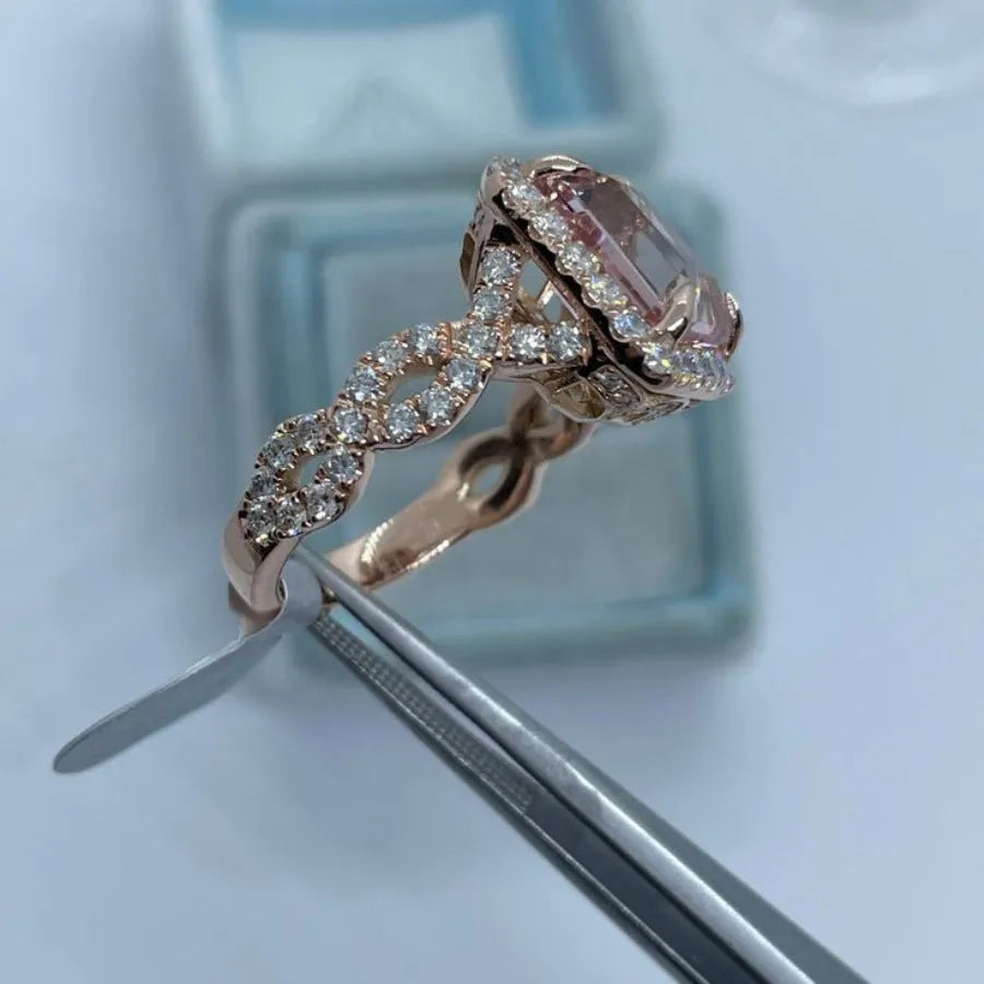 Rose gold geometric alloy ring on a plain background, showing its shape and electroplated finish.