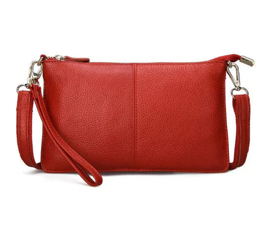 Lady's cowhide leather slant bag in apricot colour with hand strap and shoulder strap showing zipper compartments