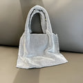 Silver ladies handbag with rhinestone embellishment on cotton thread construction and open outer pocket