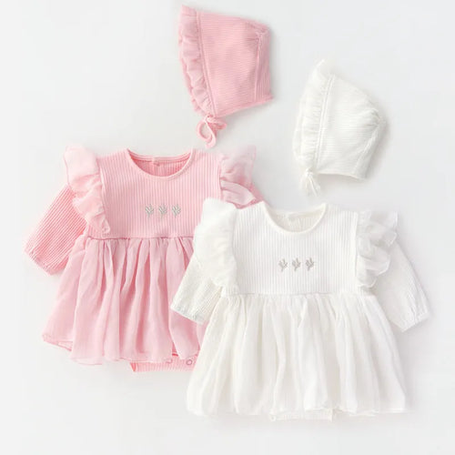 Baby girl in a soft pink cotton princess dress with a fluffy skirt, suitable for a first birthday party.