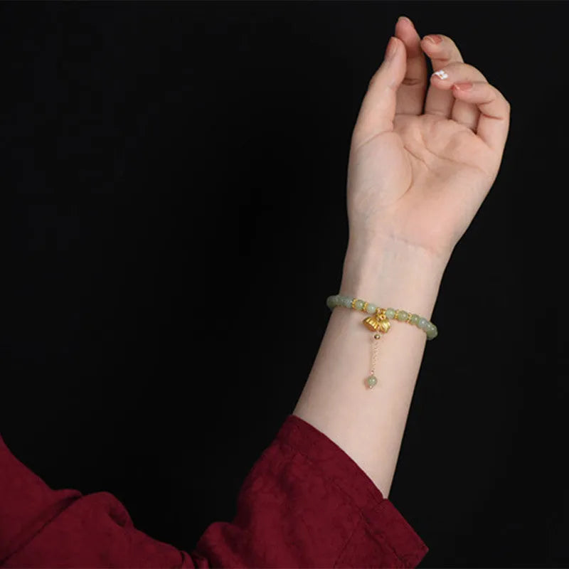 Natural Hetian Jade bracelet with six millimetre beads in step by step lotus pattern