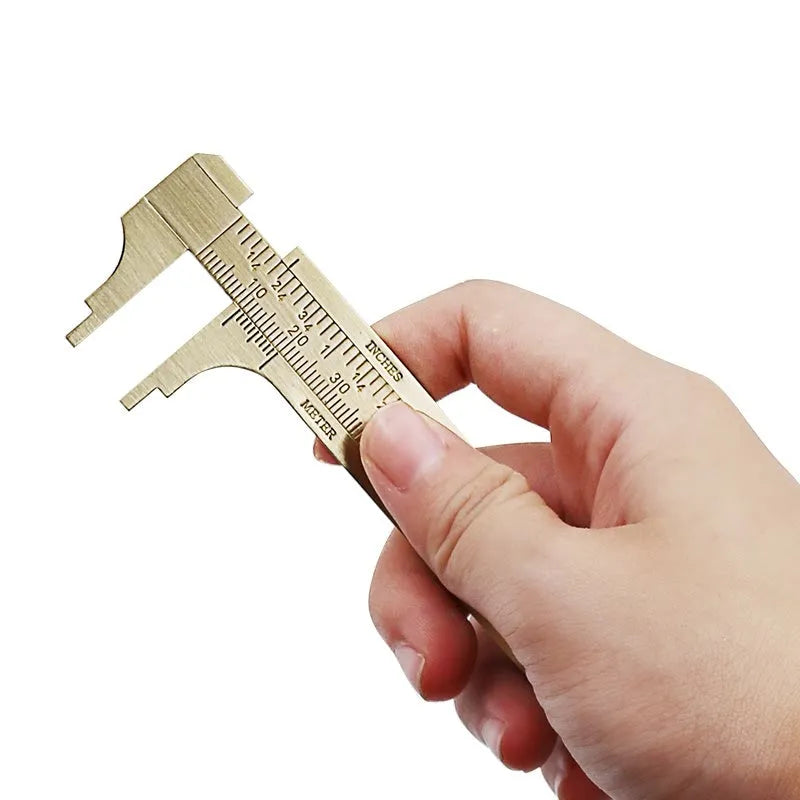 Double scale mini copper caliper with brass casting body and clear vernier markings on a white background