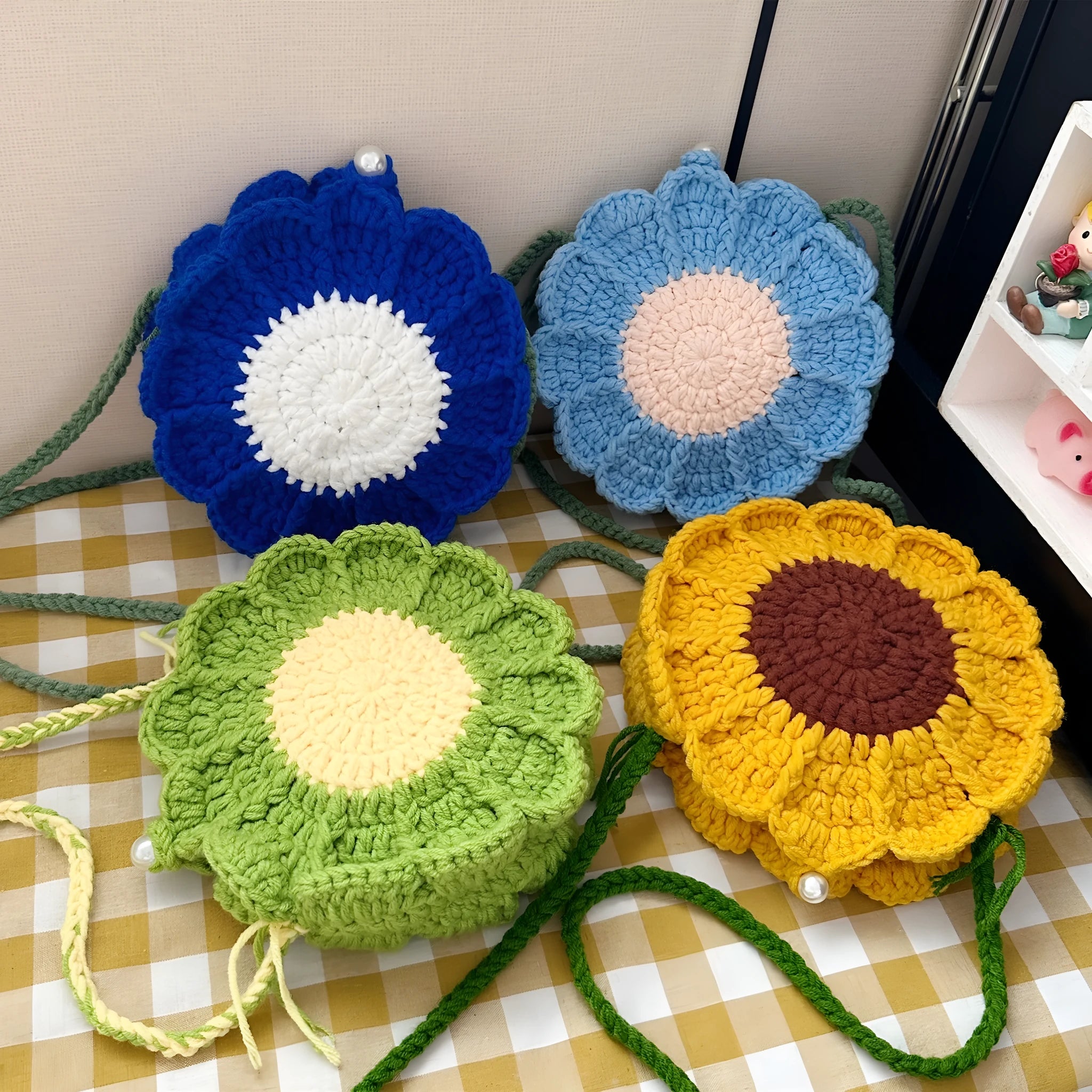 Hand-woven bag with crocheted wool flowers and mobile phone compartment in round suitcase shape