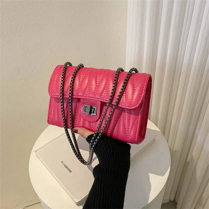 Retro textured diamond pattern women's small handbag in a choice of colours showing front view and internal phone pocket.
