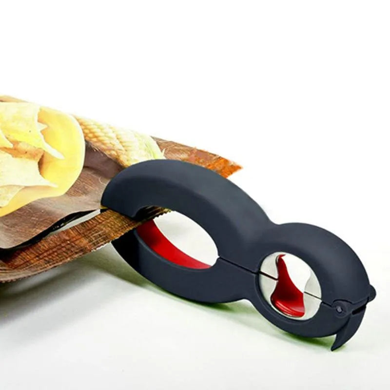 Six-in-one can opener in grey, ergonomic handle with stainless steel parts, on a kitchen counter