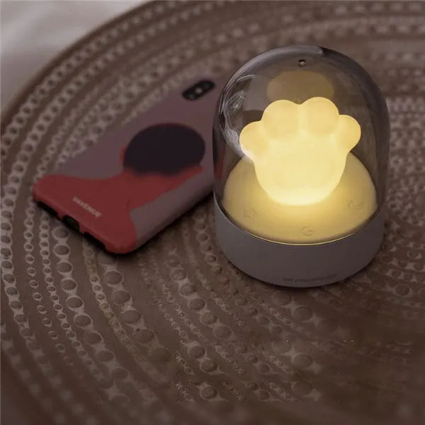 Grey cat paw shaped USB rechargeable night light with music box function on wooden desk