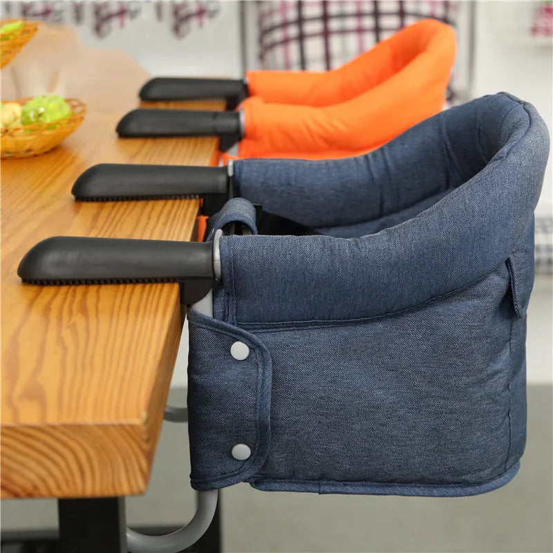 Portable baby dining seat cover with safety belt folded to show compact 42x36x7cm size