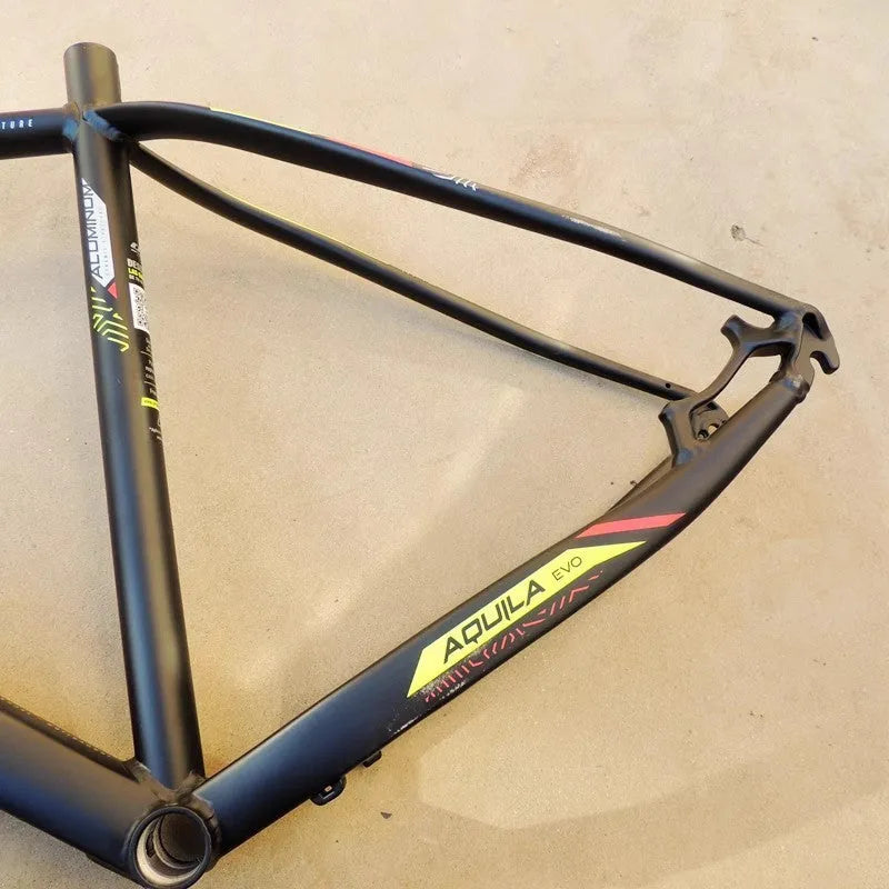Black Green 29-inch aluminium mountain bike frame showing disc brake mounts and internal cable routing ports.
