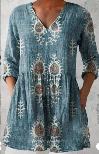 Women's floral wave print dress with wide waist and three-quarter length sleeves on a hanger.