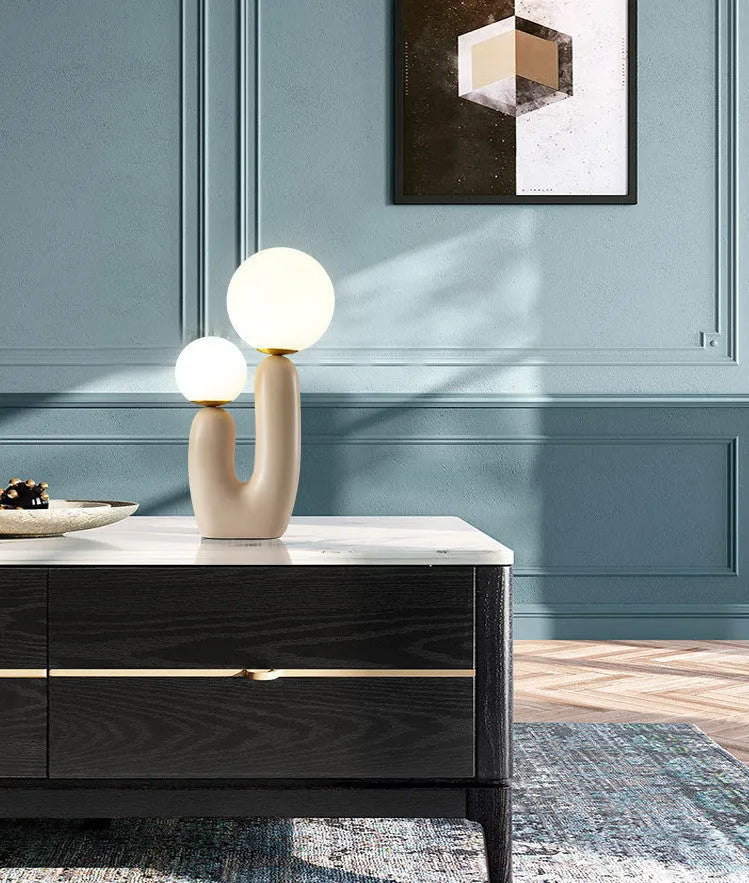 Pink double-head resin table lamp with glass shade on a bedside table, 49cm tall