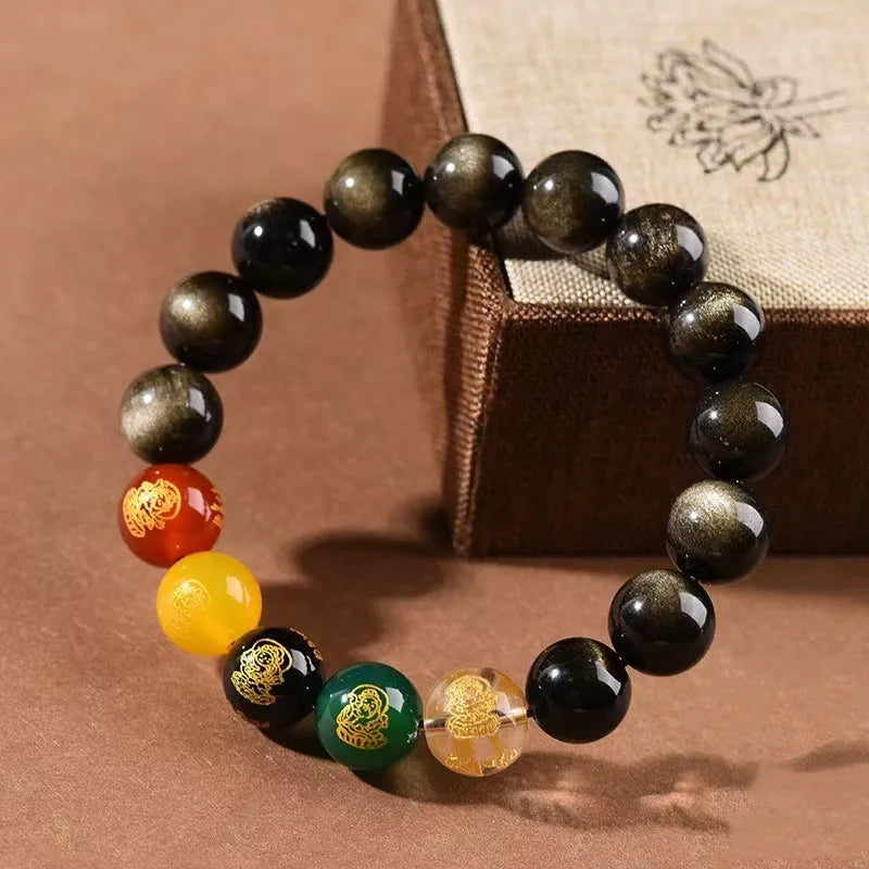 Close-up of a polished crystal bracelet with rainbow eye obsidian beads in a single circle design on a wrist.