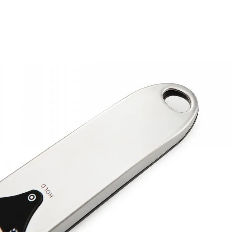 Black digital measuring spoon with LCD display showing weight measurement for kitchen use