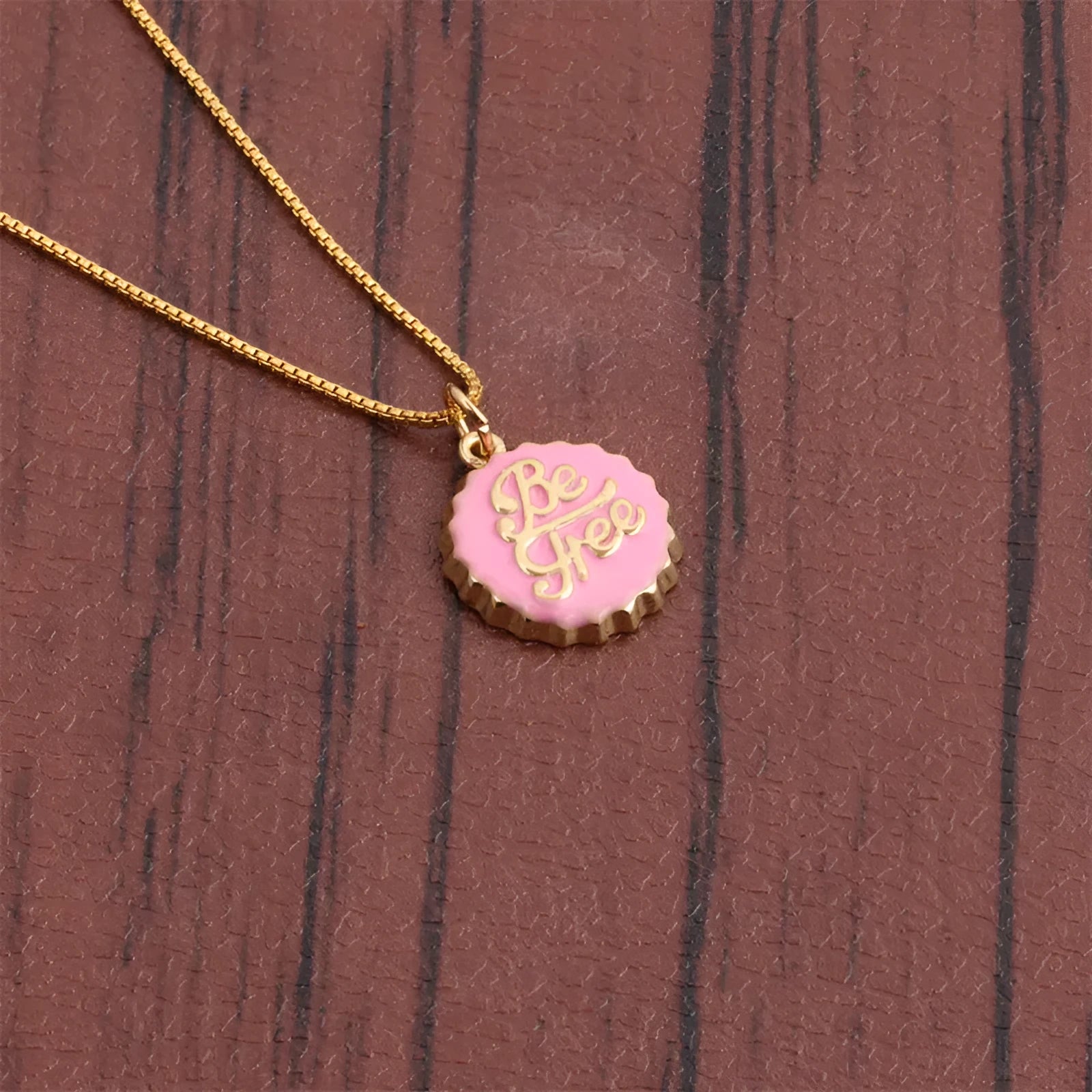 Copper electroplated bottle cap pendant necklace on a 40 cm box chain in various colours.