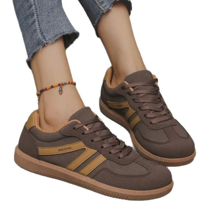 A pair of retro-style low-top lace-up sneakers in a selected colour on a plain background.