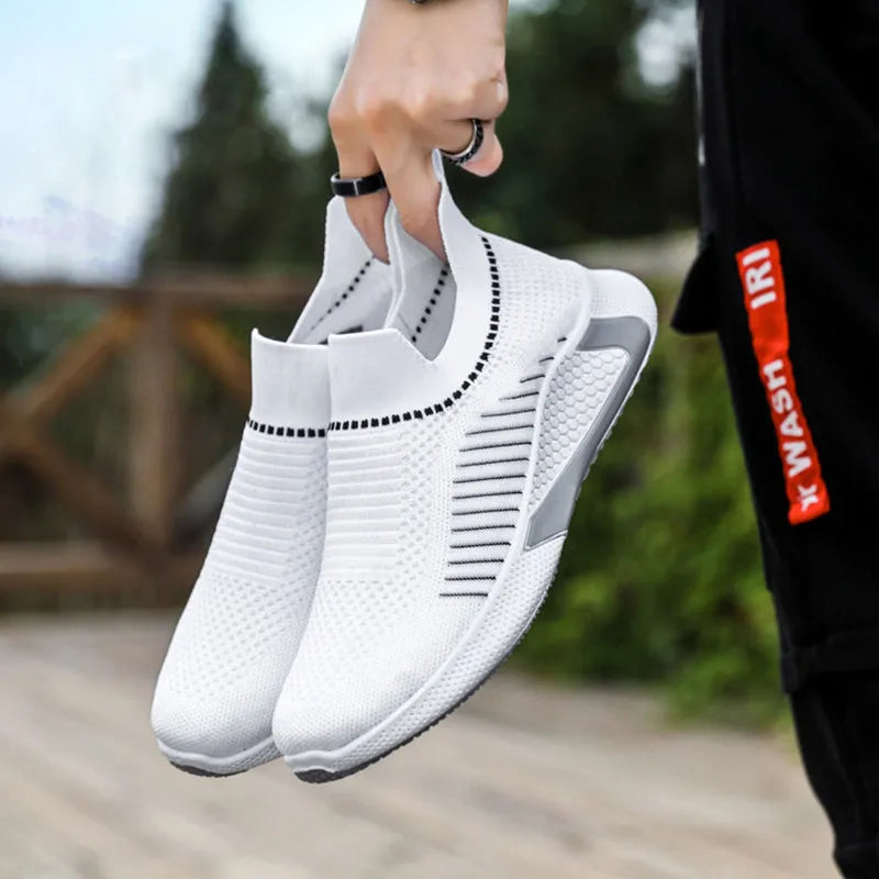 Men's black and white striped slip-on sneakers with lace-up front and mesh design.