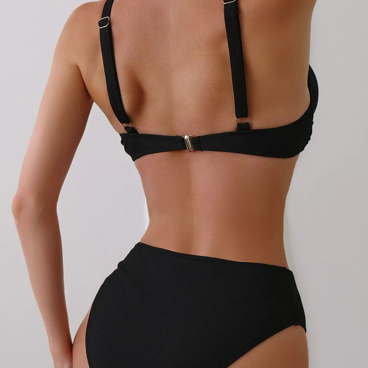 Women's solid colour ribbed fabric bikini swimsuit two-piece set on a hanger.