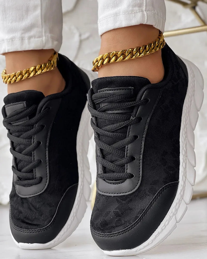 Women's canvas sports shoes in white colour showing flat heel design and round toe shape
