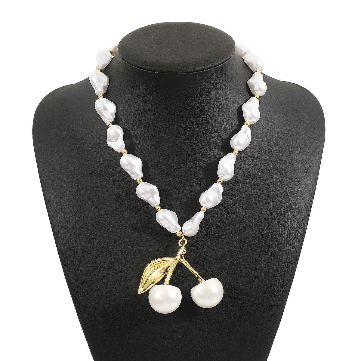 Gold fruit and geometric pendant necklace on a pearl chain, adjustable 51-60cm length.
