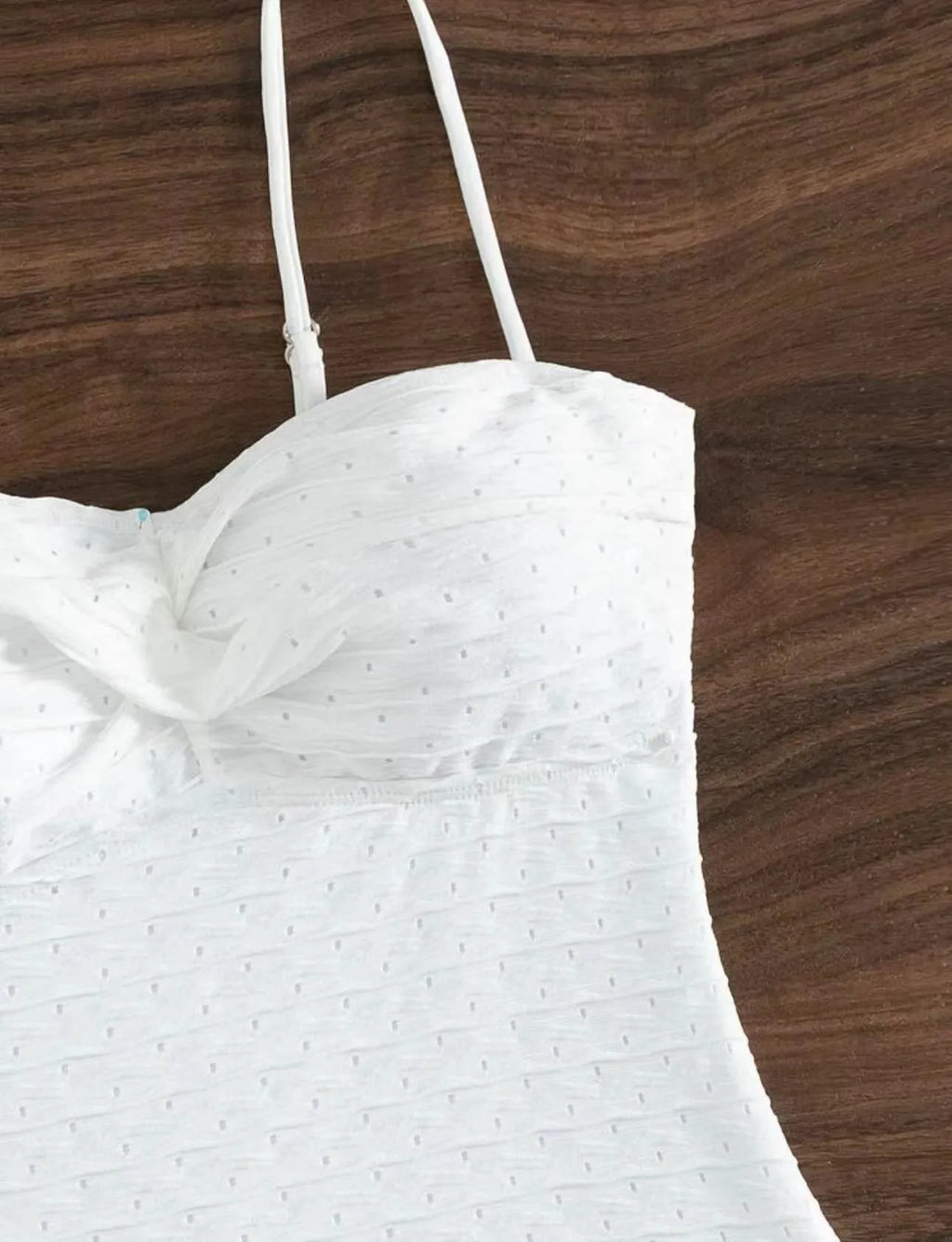 White women's one-piece swimsuit with a sling back and briefs-style cut.