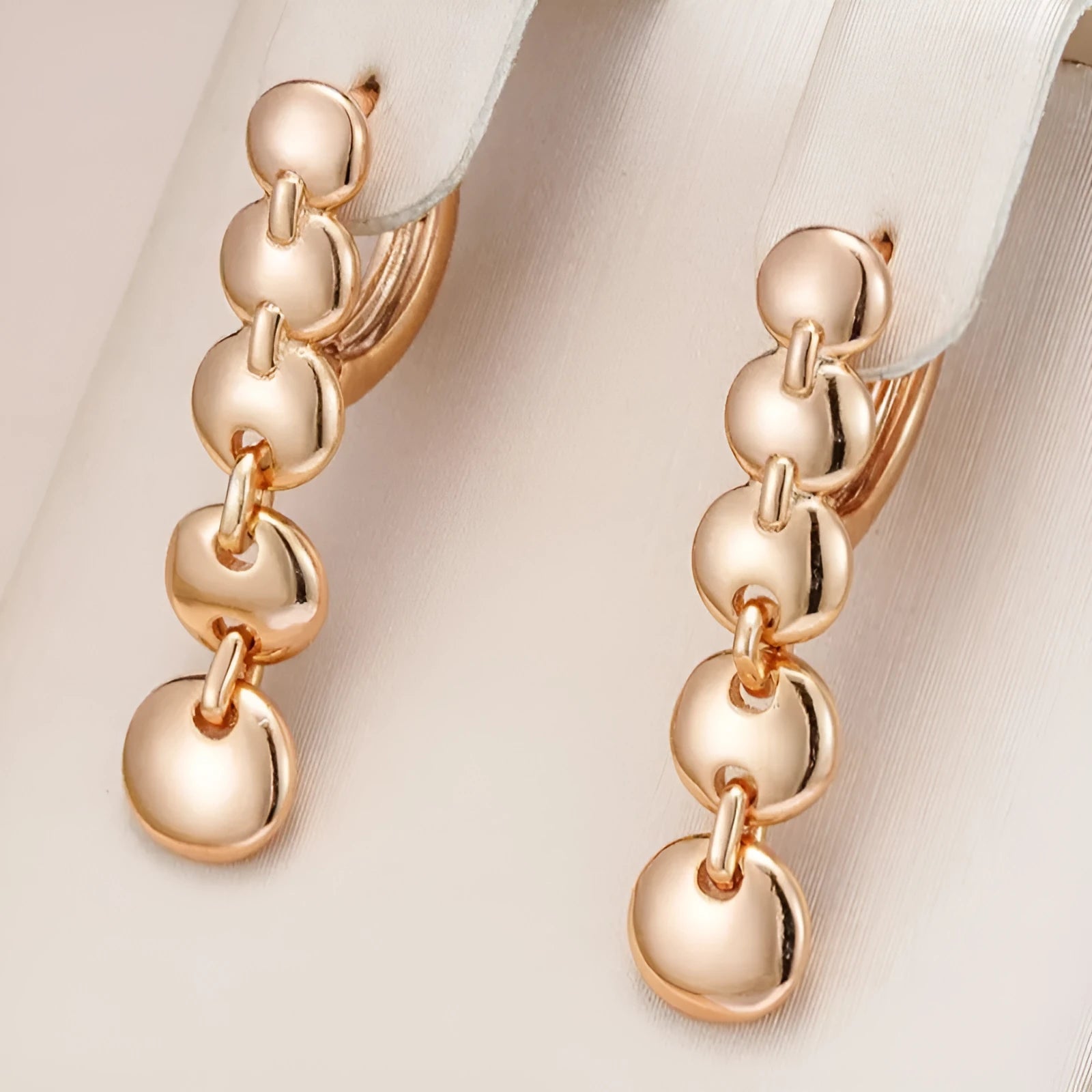 Long round gold retro earrings with woven copper texture, shown as a pair.