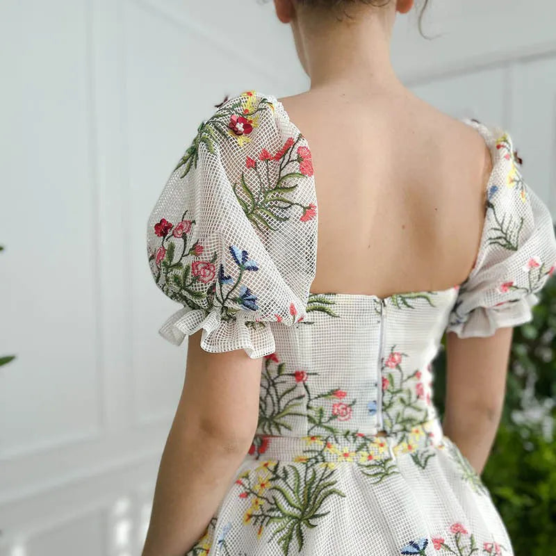 Women's fitted waist backless embroidered floral white two-piece set with mid-length skirt on white background