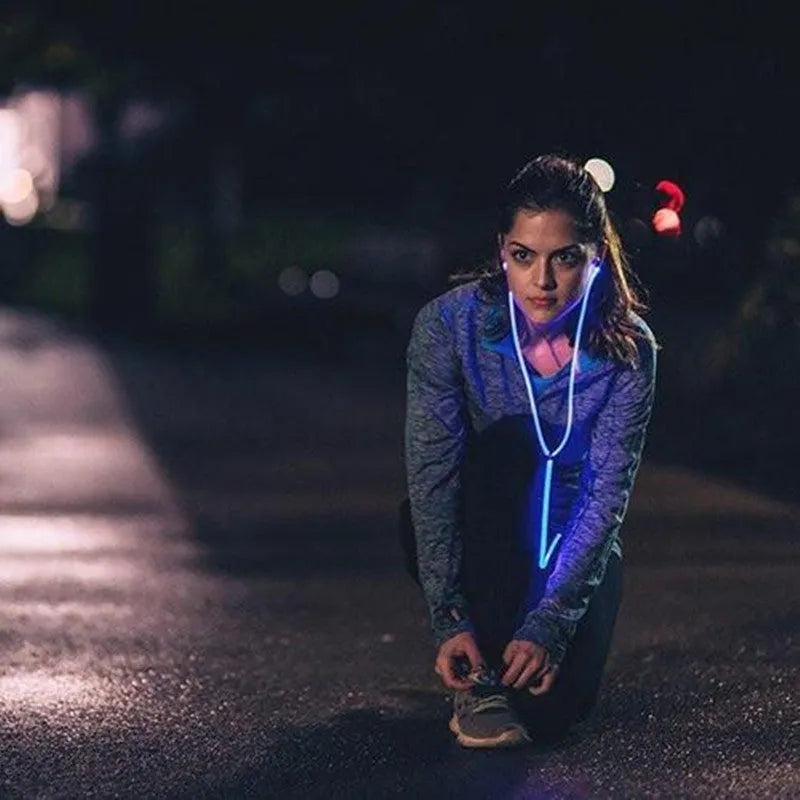 Blue Magic Light LED earphones with glowing EL light strips, showing 3.5mm plug and inline remote with microphone.