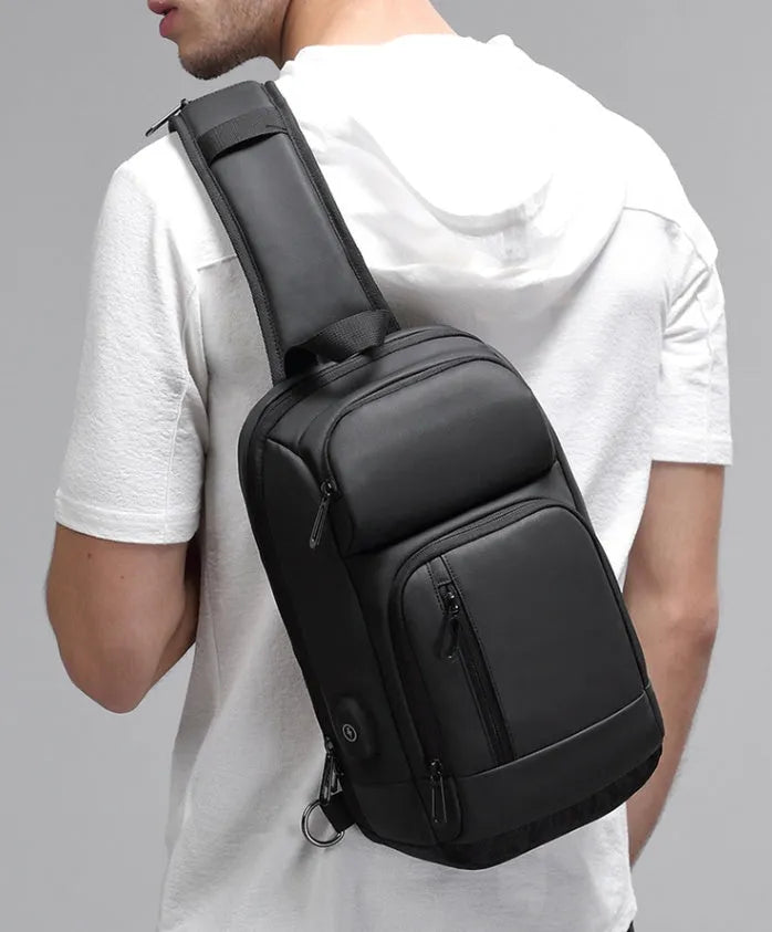 Black PVC outdoor shoulder bag with zipper, internal pockets, and an air cushion shoulder strap.
