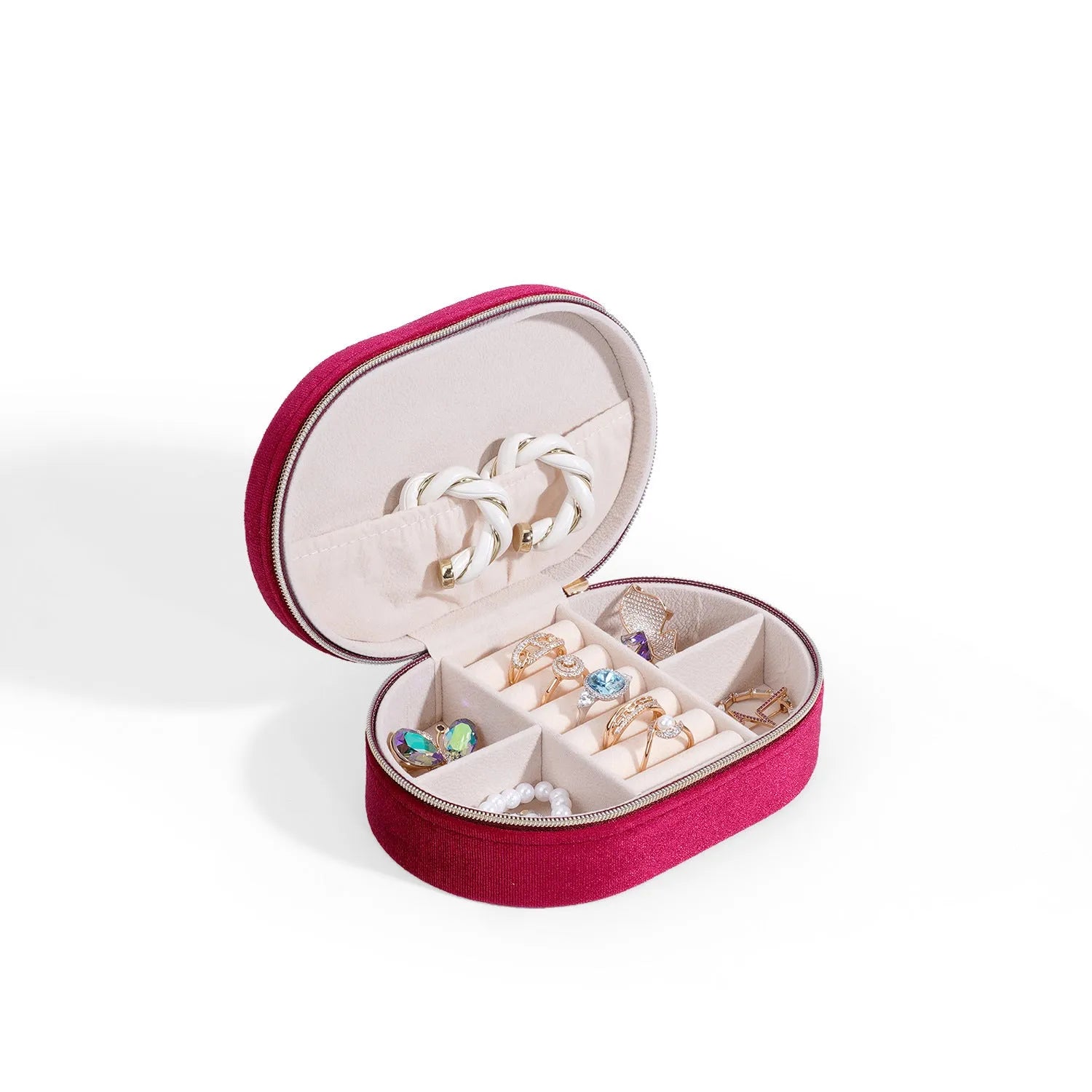 Oval velvet jewellery storage box in multiple colours with flannel lining, showing compact 15x10x5 cm size.