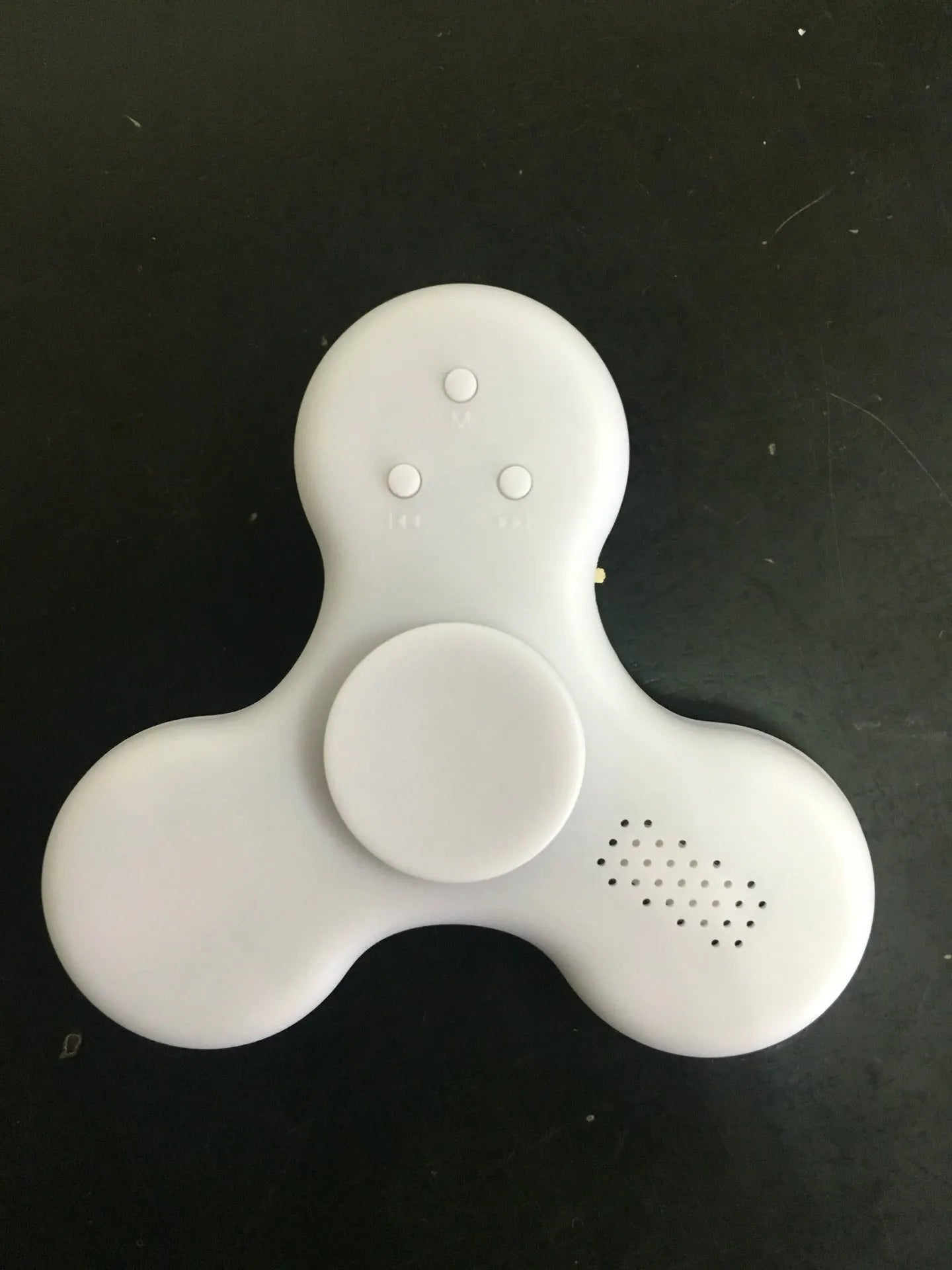 Compact white Bluetooth speaker and MP3 player designed as a fidget spinner toy.