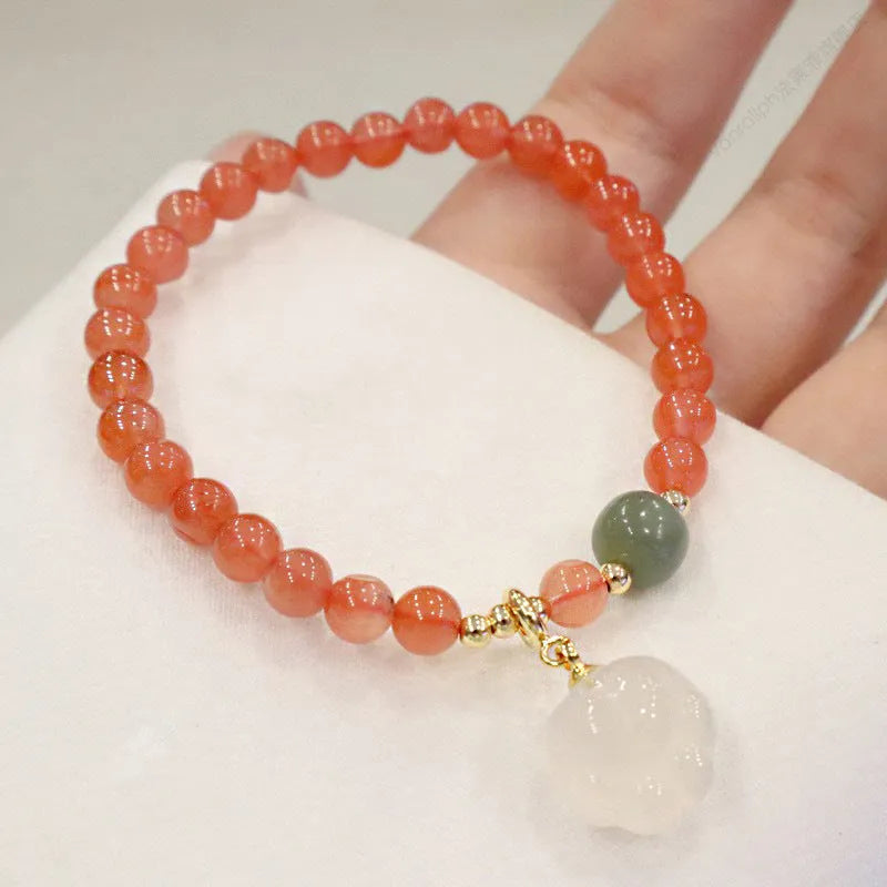 Natural red agate bracelet with jade inlay and a cat paw charm on a 6mm band.