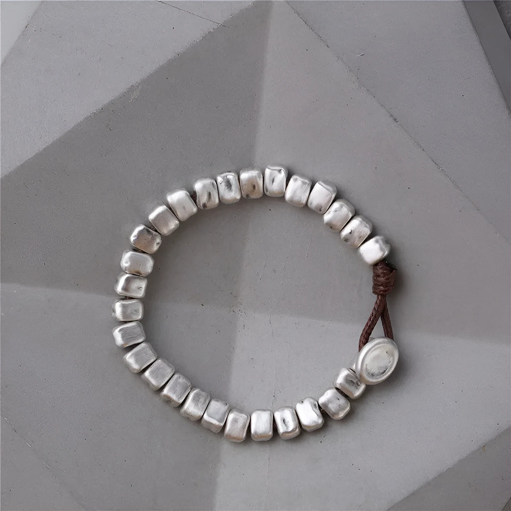 Handmade women's bracelet with irregular square design in wood and silver materials on elastic band