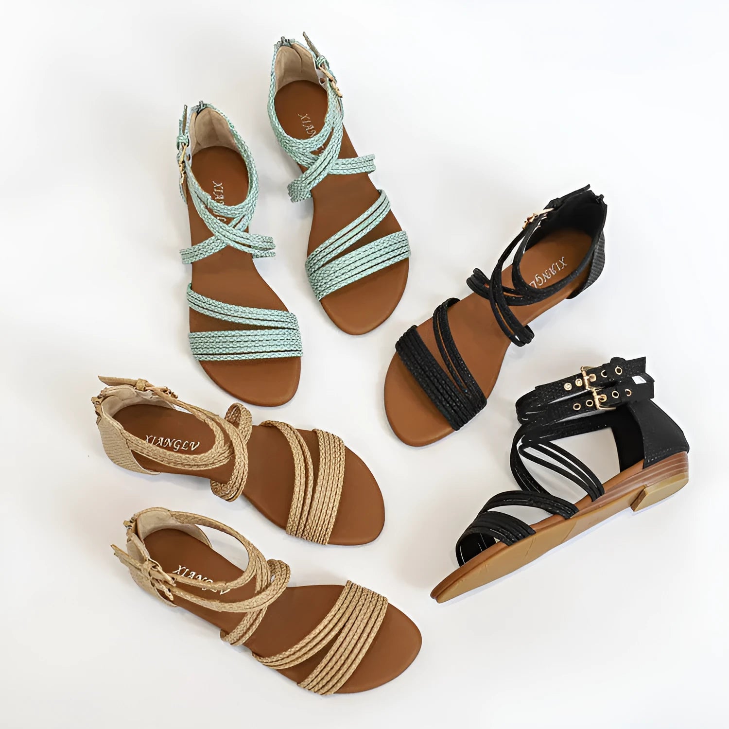Women's black open toe Roman sandals with cross straps, a buckle, and a back zipper.