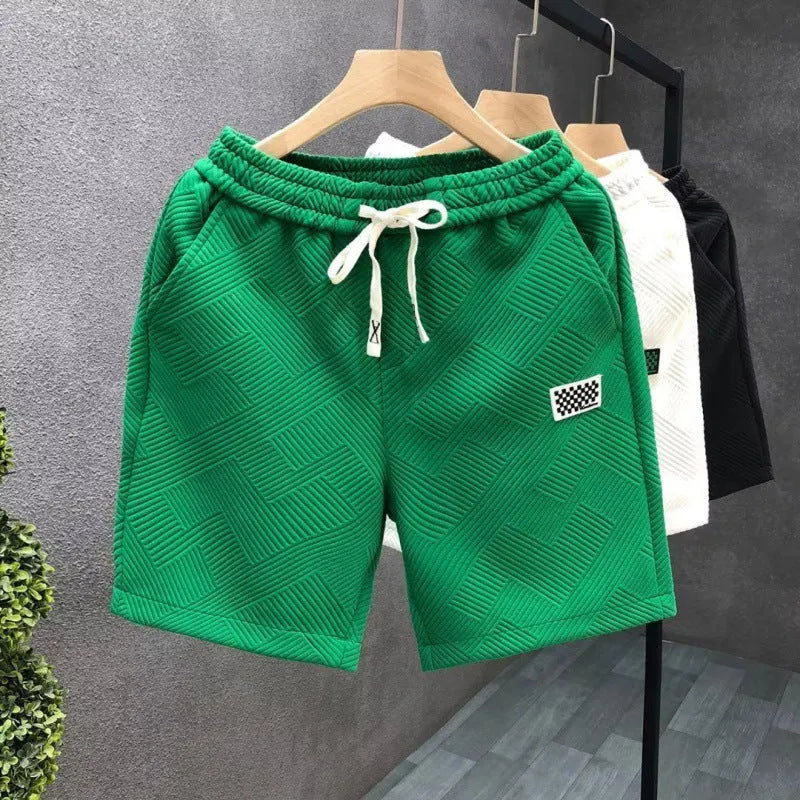 Men's casual sports shorts in polyester fabric showing elastic waistband and solid colour options