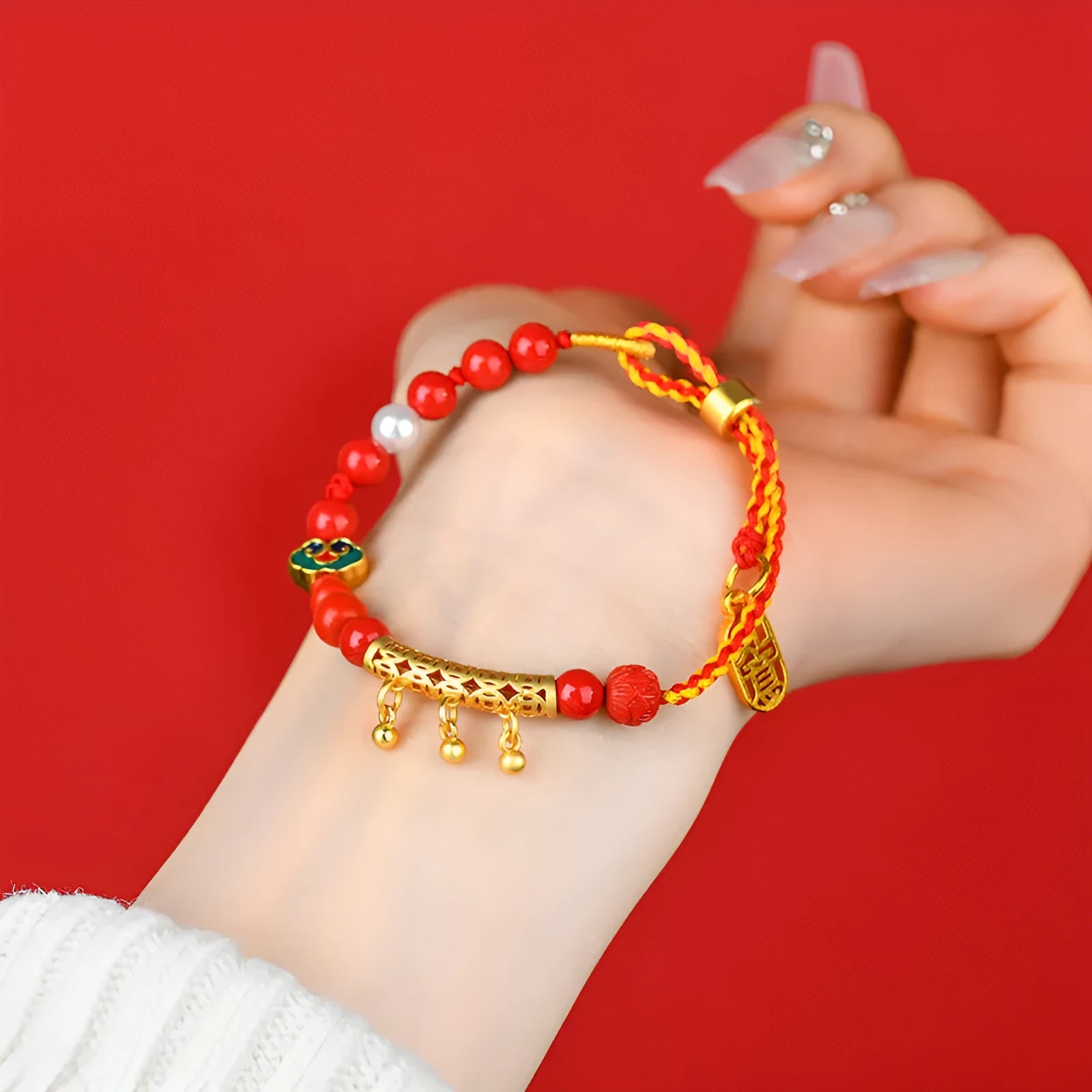 Women's hand-woven cinnabar rope bracelet with round bell charm in emperor red sand colour