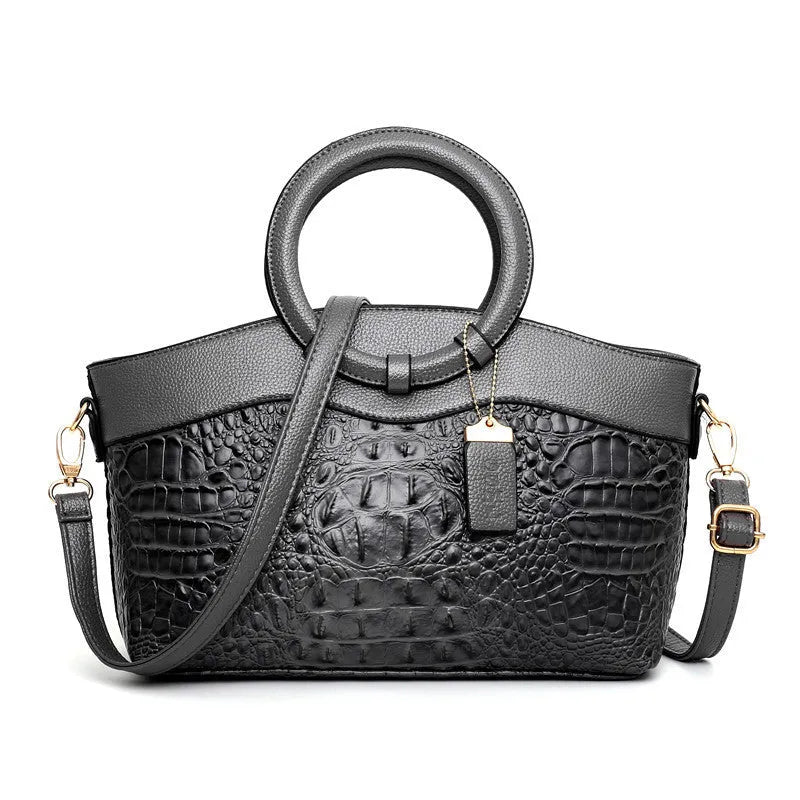 Ladies fashion handbag in multiple colours showing zipper compartments and shoulder strap