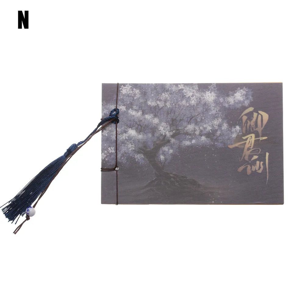 Hand-stitched kraft paper notebook with tassel bookmark on blank pages.