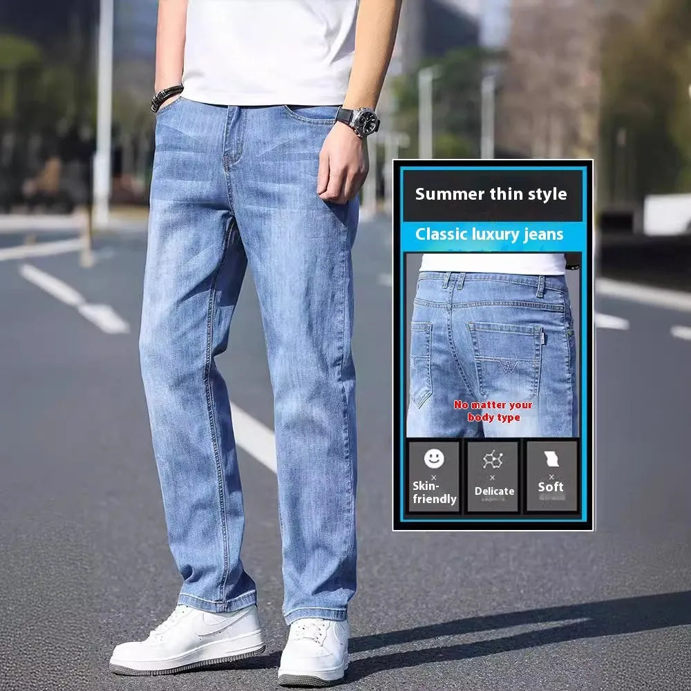 A pair of tapered fit stretch denim trousers in a light blue colour, laid flat.