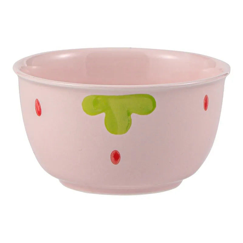 Cute porcelain dinnerware set with strawberry design, instant noodle bowl, twist spoon, and flower-shaped plates on table.