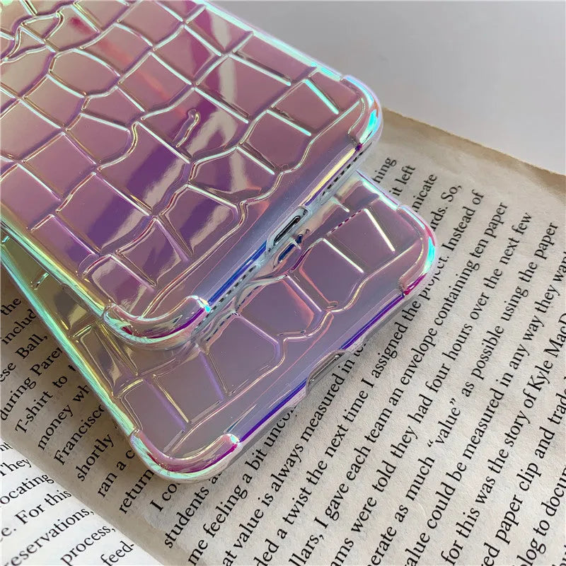Glossy silver silicone phone case with a laser-etched irregular texture for iPhone, showing raised camera protection.