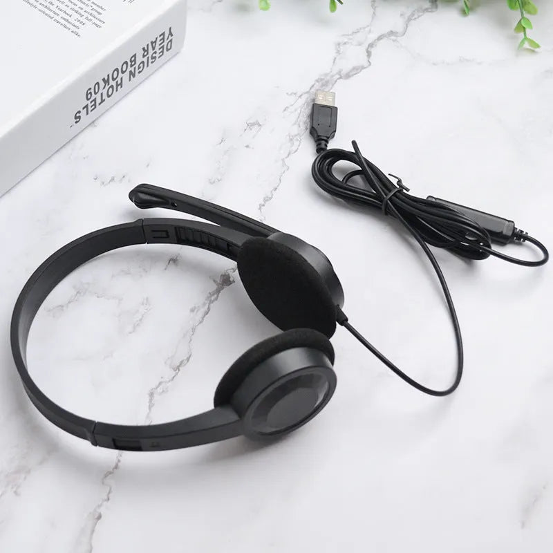 Black wired USB headset with sponge ear cushions and microphone for computer gaming and calls